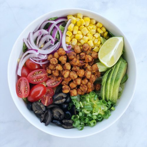 Chickpea Taco Salad is an easy vegan dish that comes together with seasoned garbanzo beans and your favorite taco toppings piled high on a bed of greens.