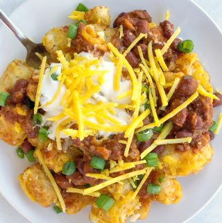 Loaded Tater Tot Nachos with dairy-free cheese, chili, and sour cream
