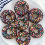 Vegan Chocolate Glazed Donuts come together with 10 ingredients and bake in just 15 minutes! They are soft and fluffy, with a delicious glaze and sprinkles
