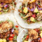 Roasted Cauliflower and Chickpea Tacos with Pineapple Salsa is a healthy and filling meatless meal, perfect for any day of the week. Plant-based, dairy-free, and gluten-free!