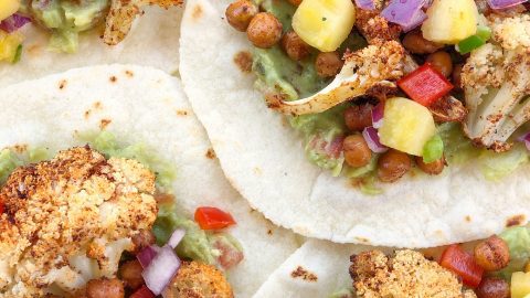 Roasted Cauliflower and Chickpea Tacos with Pineapple Salsa is a healthy and filling meatless meal, perfect for any day of the week. Plant-based, dairy-free, and gluten-free!