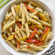 rasta pasta with bell peppers in a white bowl.