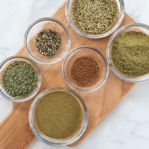 homemade poultry seasoning ingredients in bowls.
