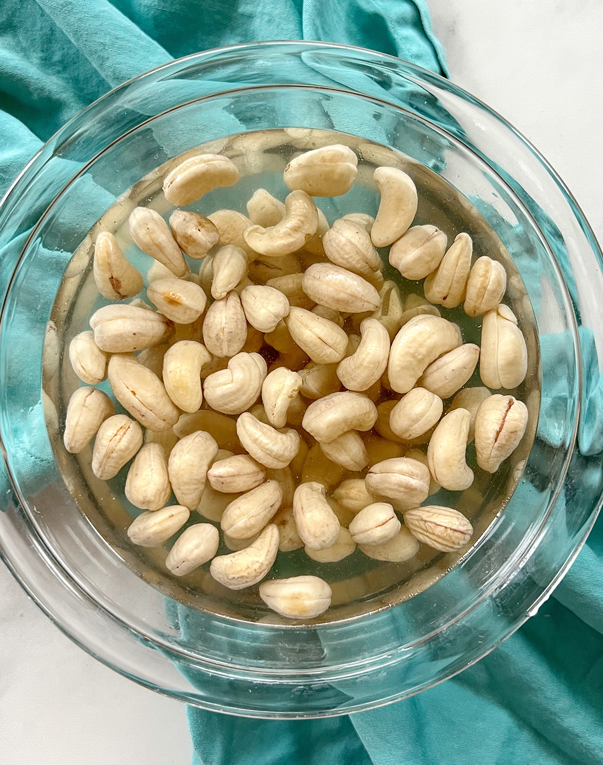 soaking raw cashews in bowl of water