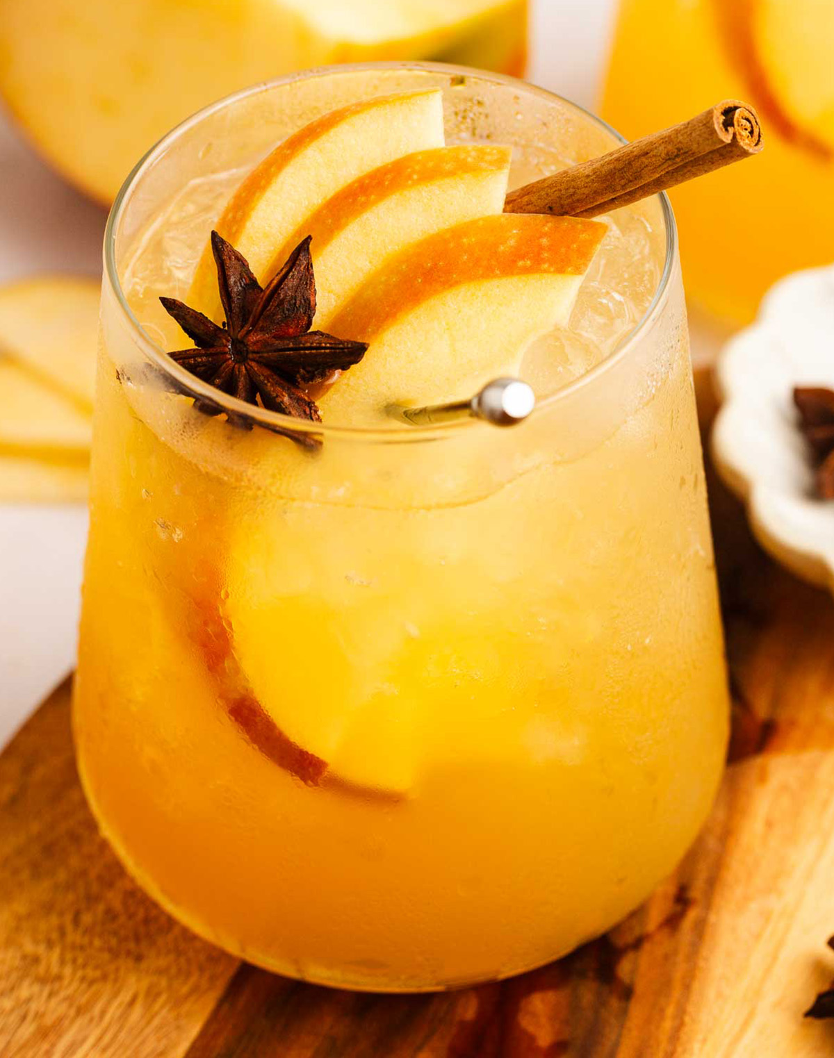 Apple cider ginger beer mocktail garnished with apple slices, cinnamon, and star anise