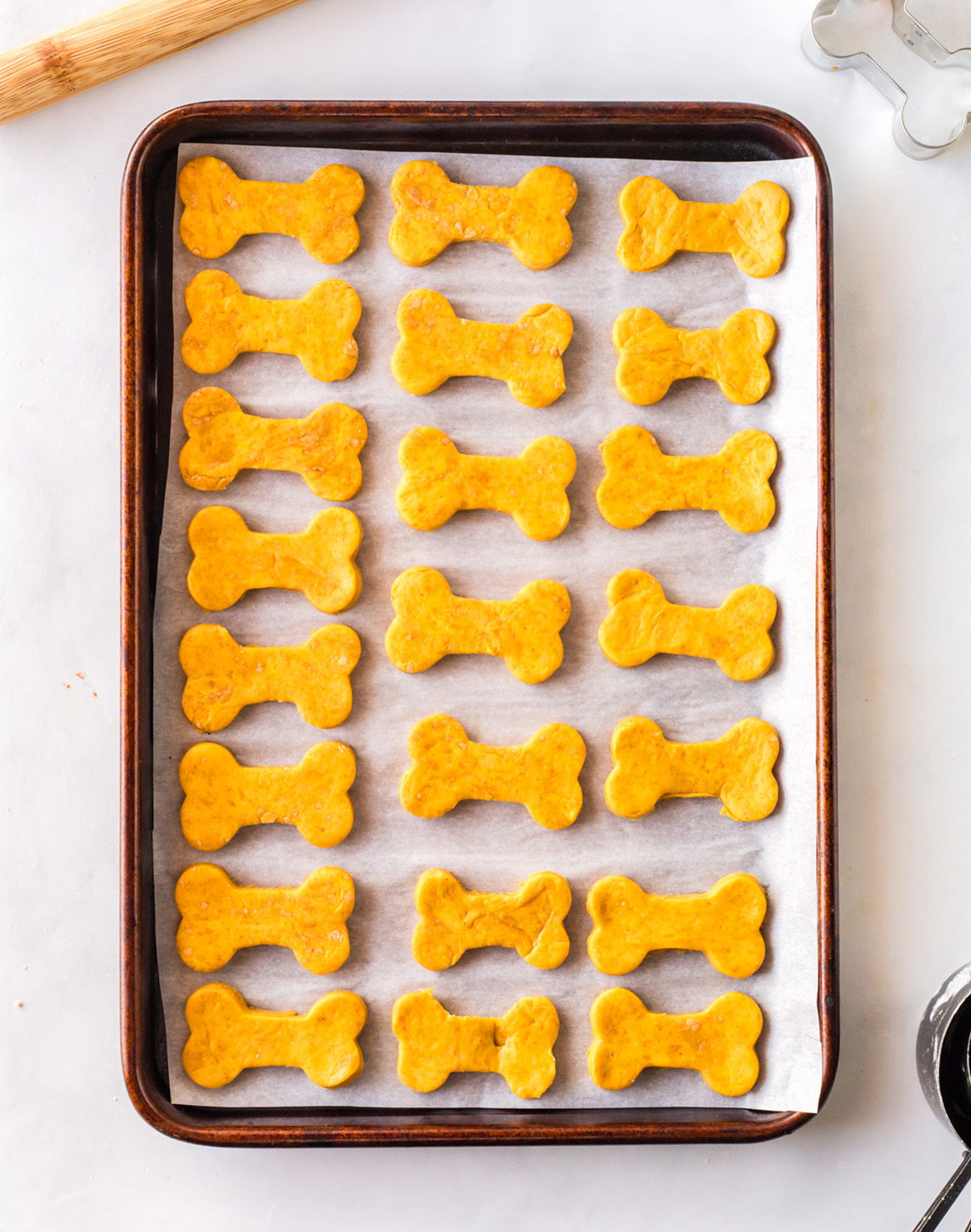 Bone-shaped dog treats cut from rolled dough