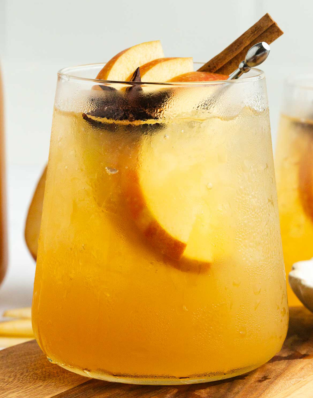 Apple cider ginger beer mocktail with fall spices and sliced apples