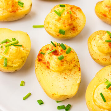 Close up of eggless deviled potatoes with creamy filling and chives.