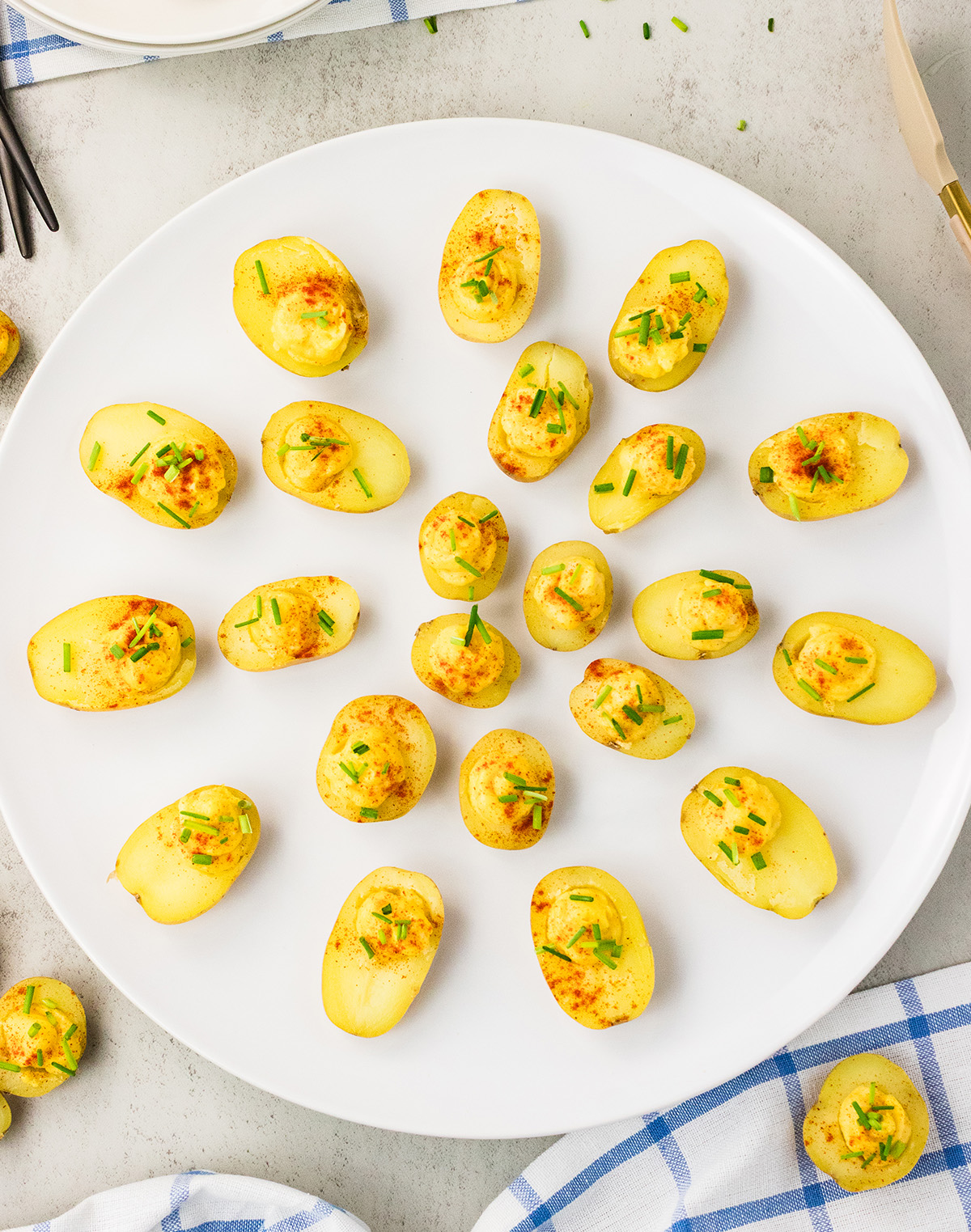 Platter of vegan deviled potatoes with green onion and smoked paprika.