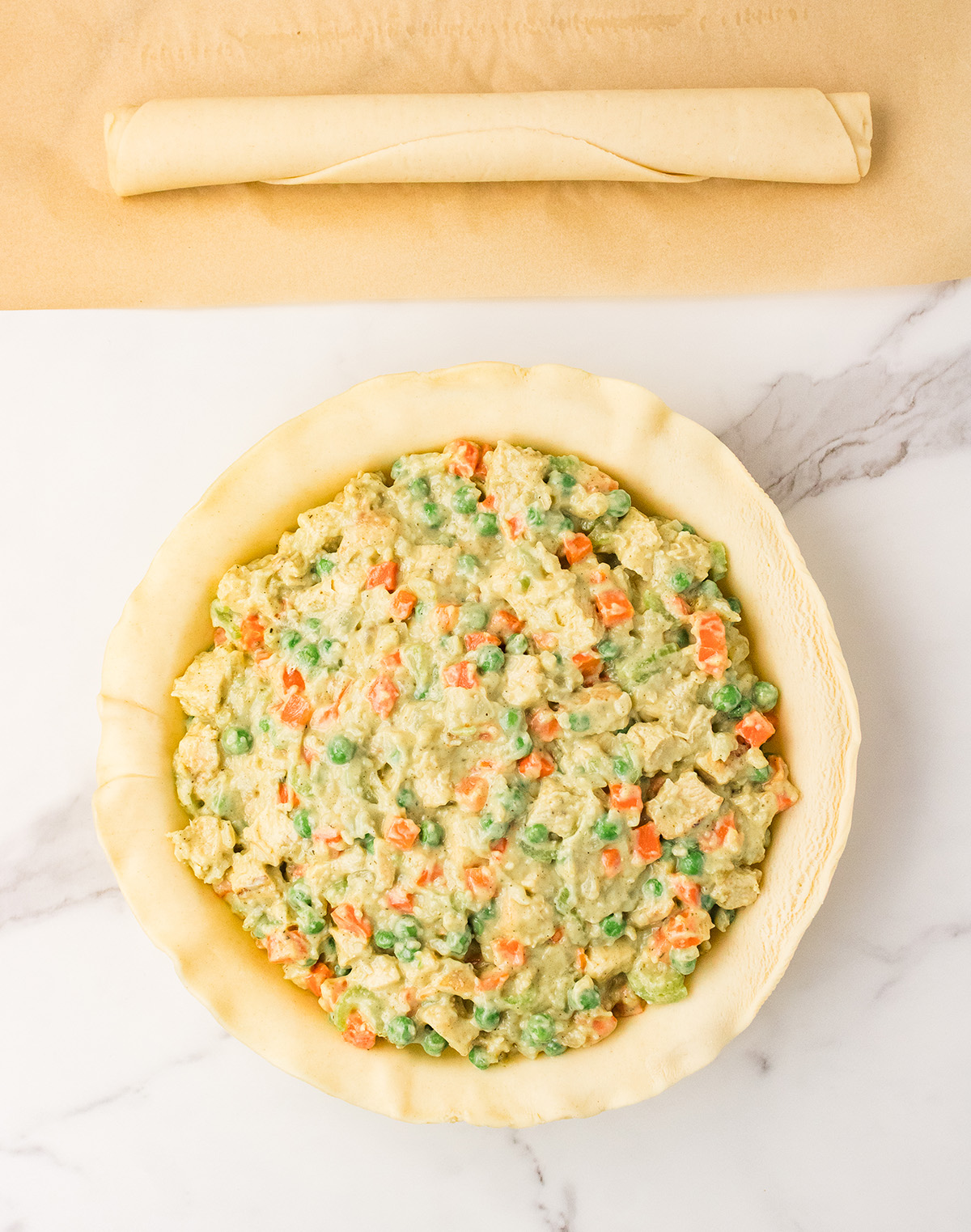 assembling pot pie with pie crust