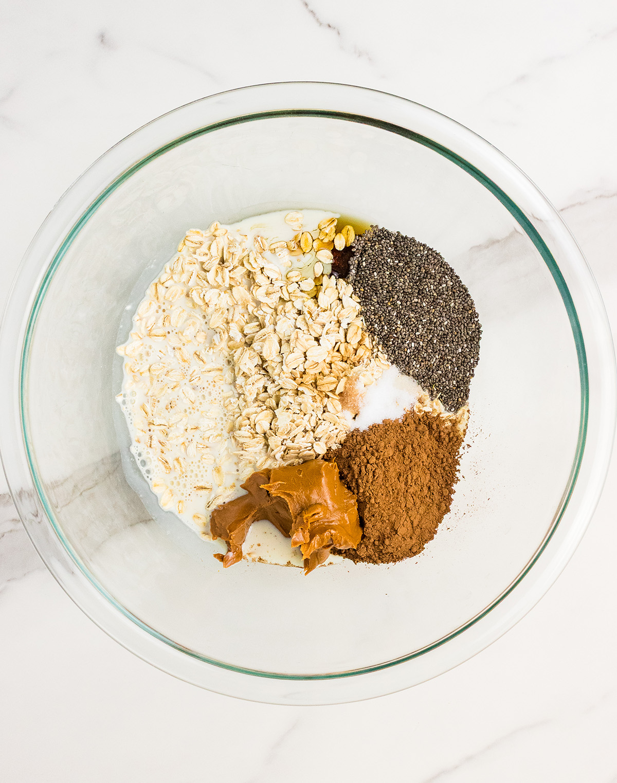 peanut butter cocoa overnight oats ingredients in mixing bowl