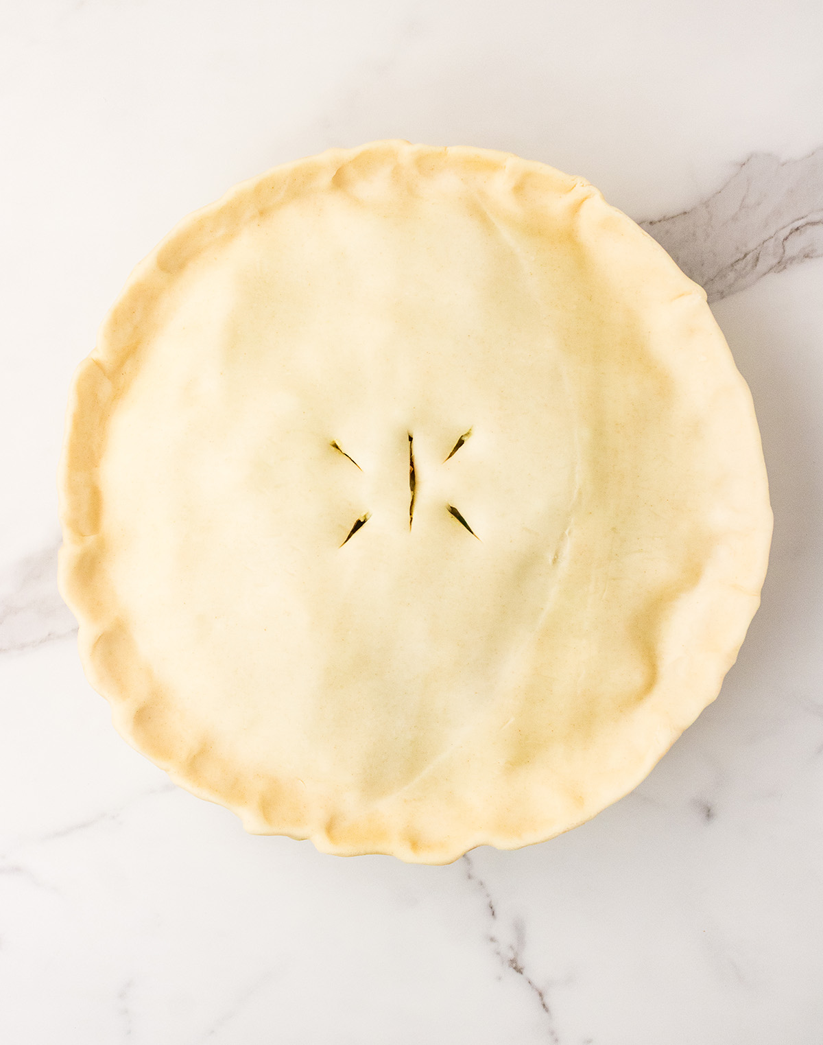 unbaked chicken pot pie in pie dish